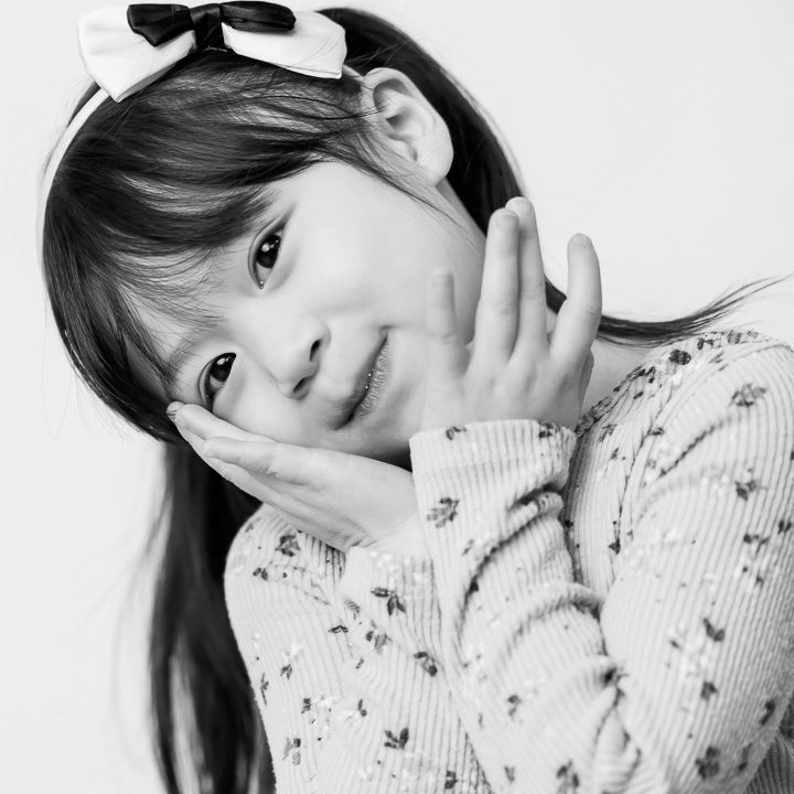 Black & White kids photo on a white backdrop - little girl with pigtails by Paper Bunny Studios