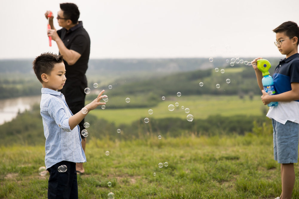 Edmonton outdoor documentary family photography of boys playing with bubbles by Paper Bunny Studios