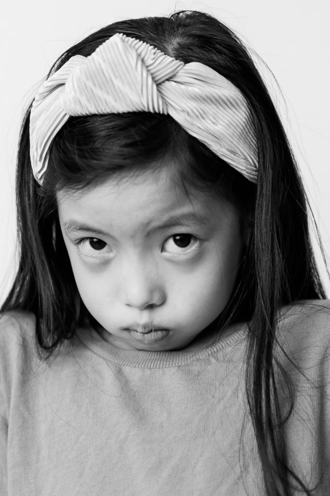 Classic black & white kids portrait photography -young girl being expressive by Paper Bunny Studios Edmonton 