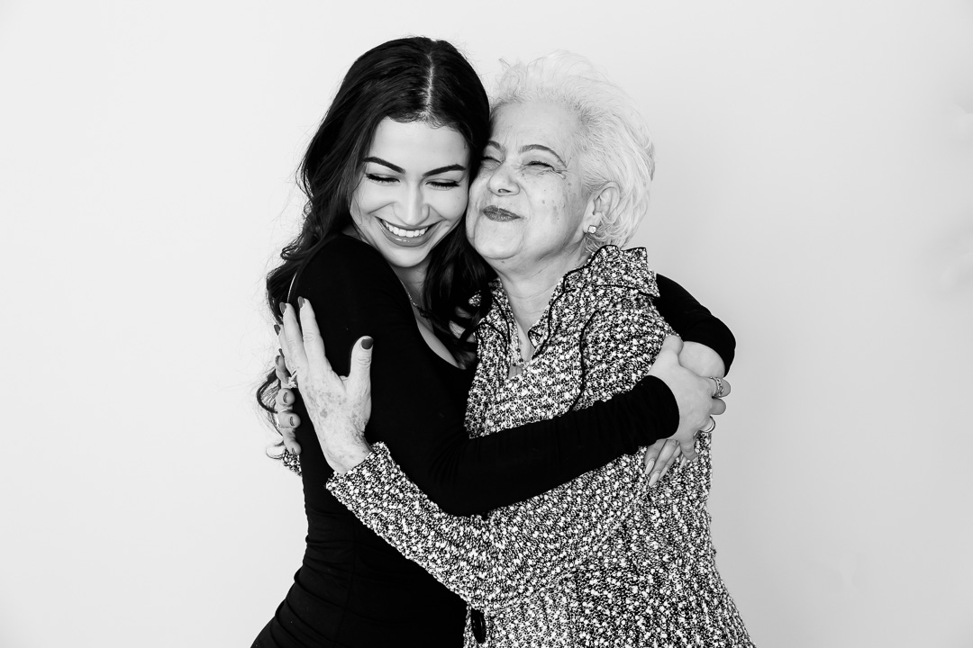 Mother & grown up daughter hugging black & white portrait photography by Paper Bunny Studios