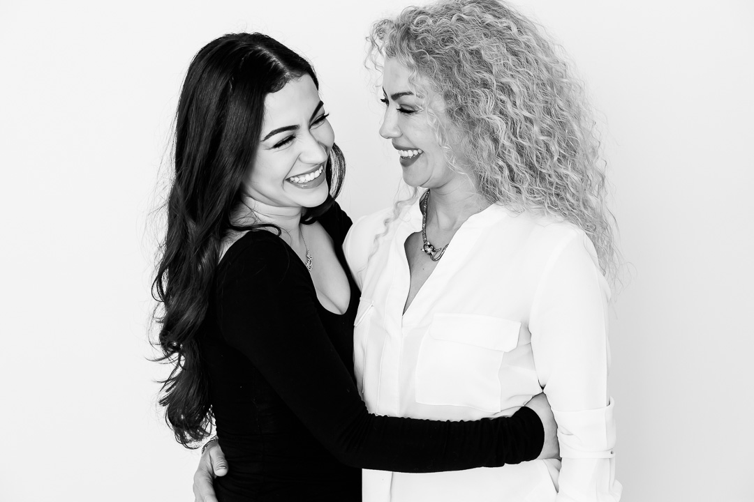 Sisters sharing a moment of joy - black & white portrait photography by Paper Bunny Studios