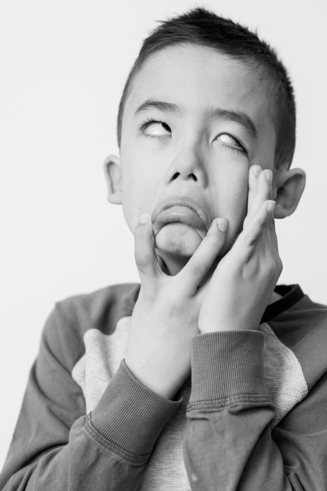 Classic black & white kids portrait photography - young boy pulling a funny expression by Paper Bunny Studios Edmonton 