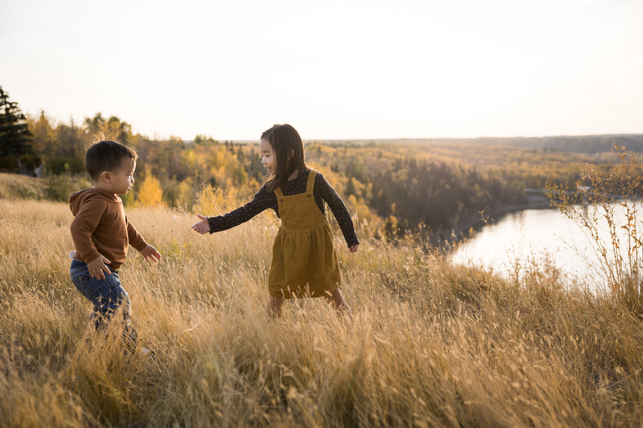 Edmonton outdoor Fall family photos - brother & sister playing in field - by Paper Bunny Studios