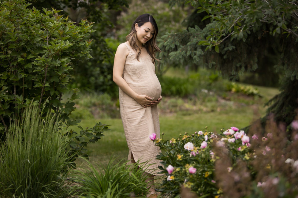 Outdoor maternity photos with greenery & flowers by Paper Bunny Studios Edmonton