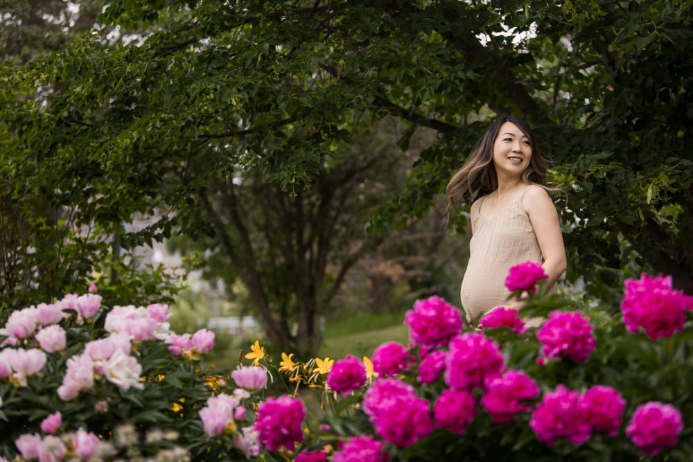 Outdoor maternity photos with flowers by Paper Bunny Studios Edmonton