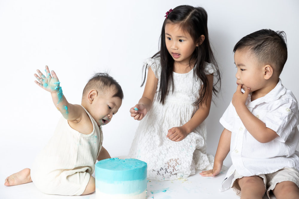 First Birthday Cake Smash photography - big sister not too impressed by Paper Bunny Studios Edmonton