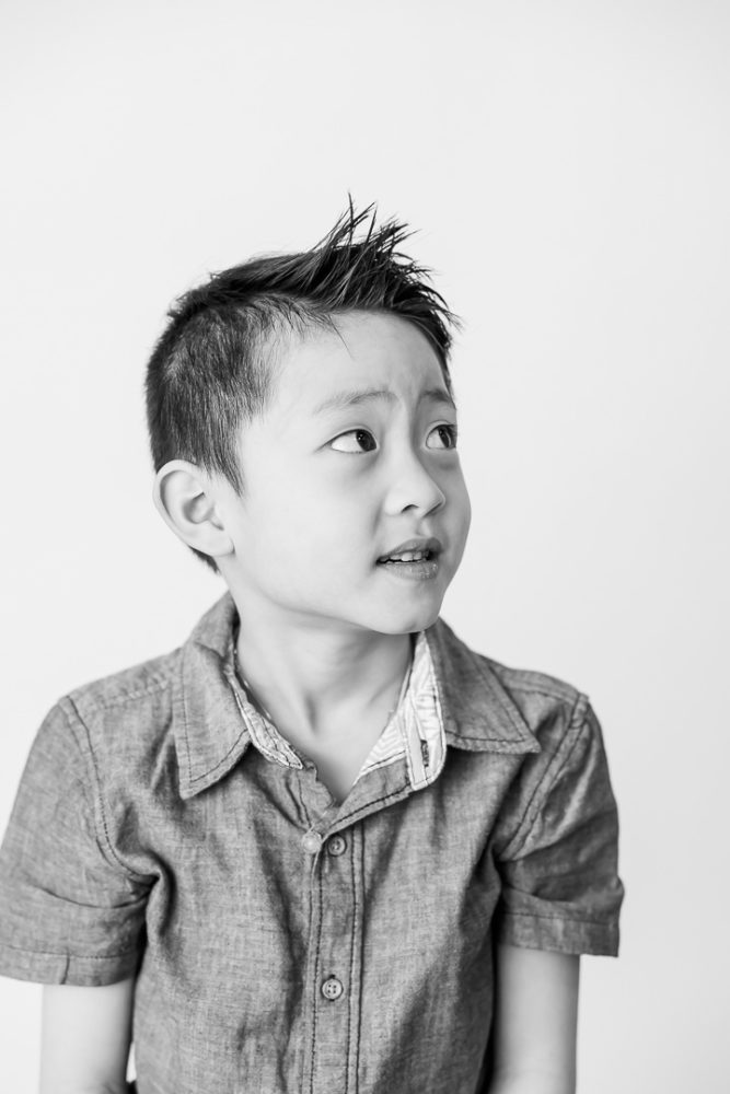 Classic black & white kids portrait photography - young boy looking off to side tentatively by Paper Bunny Studios Edmonton 