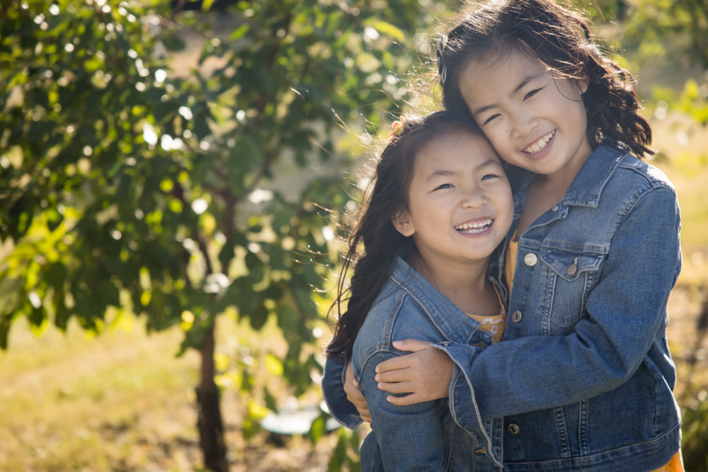 Family portrait photography - daughters in matching denim jackets by paper bunny studios edmonton