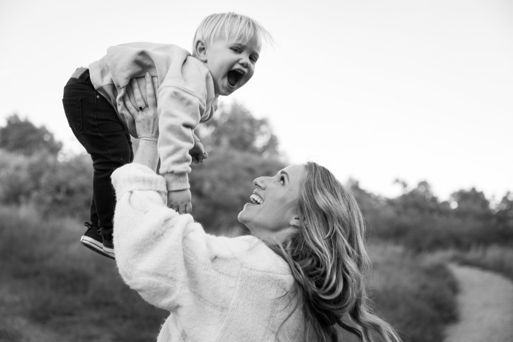 Edmonton Fall family photos - toddler being held up high by mom by Paper Bunny Studios