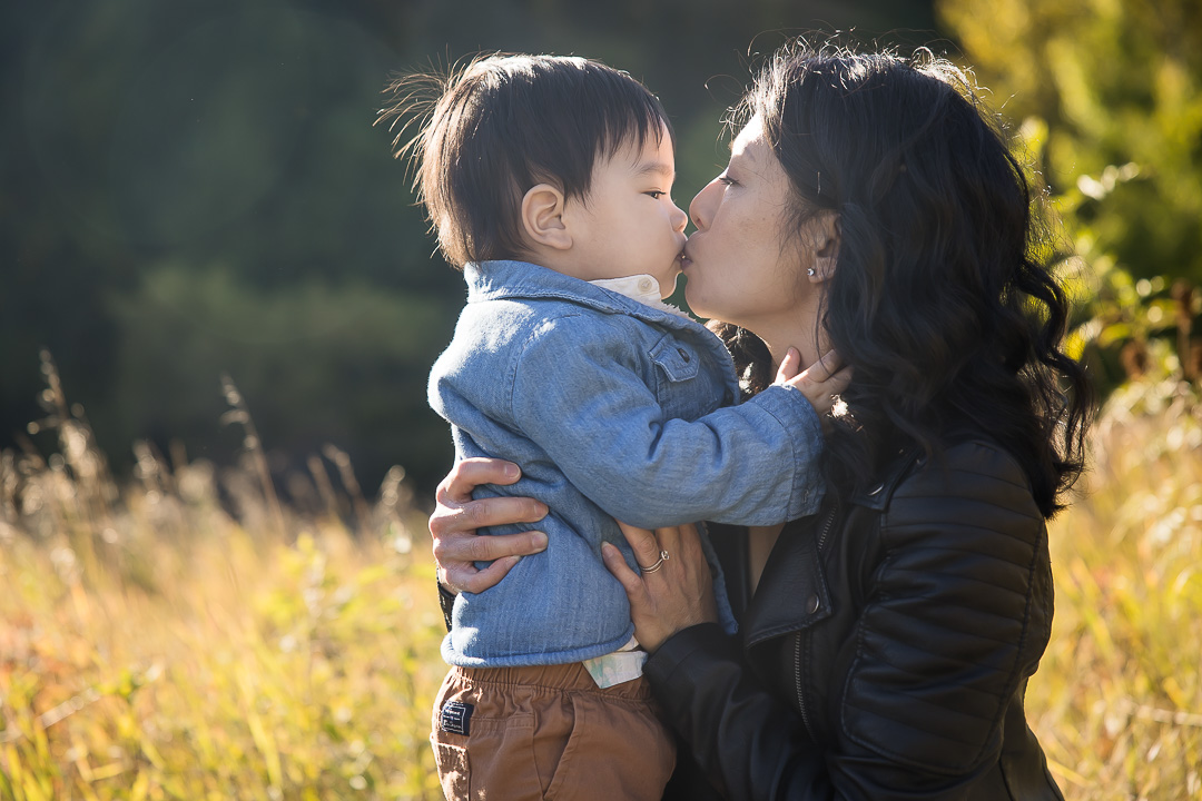 Holmann family photos mother & son kissing - outdoor family photos in Edmonton