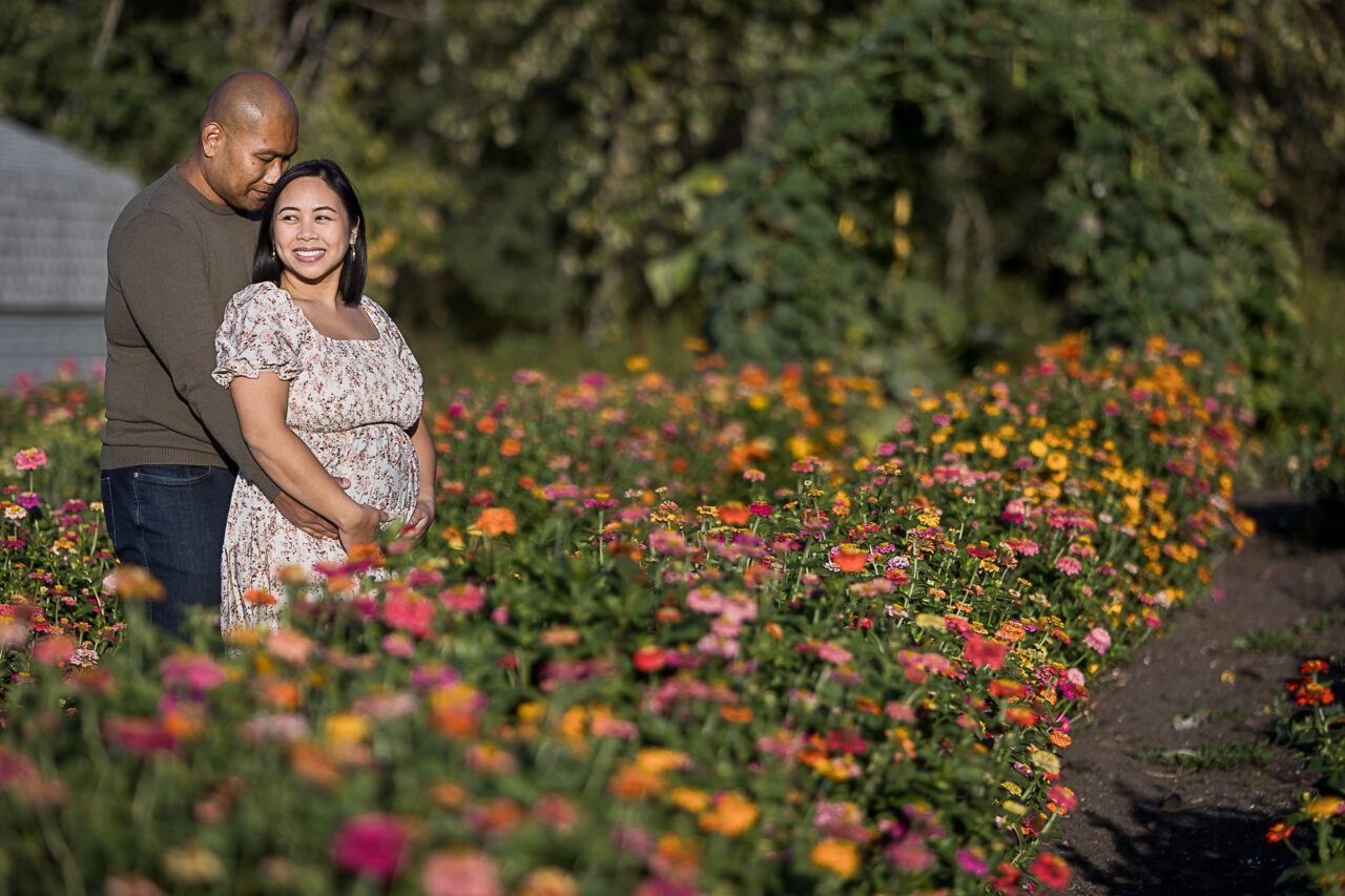 Mom & dad in a field of flowers by Edmonton family photographer Paper Bunny Studios