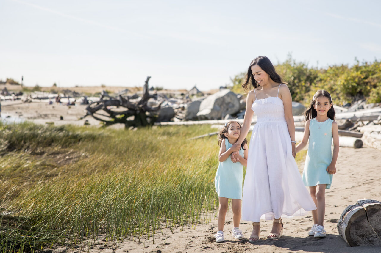 Mom and daughters walking on beach by documentary family photographer Paper Bunny Studios