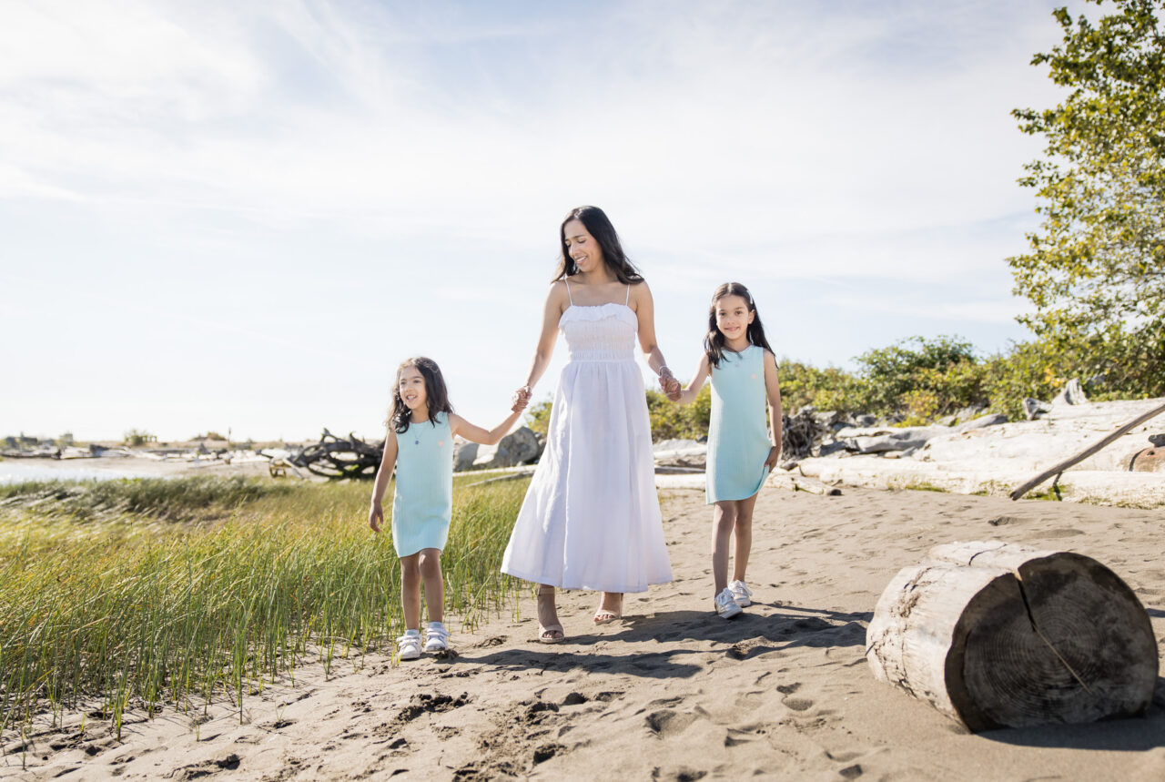 Mom and daughters walking along beach by documentary family photographer Paper Bunny Studios
