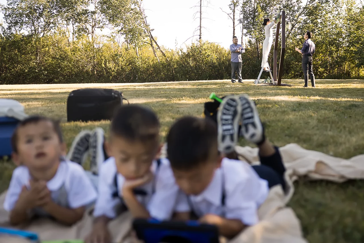 Documentary family photography for vow renewal boys chilling on ipad as parents prep by Paper bunny studios
