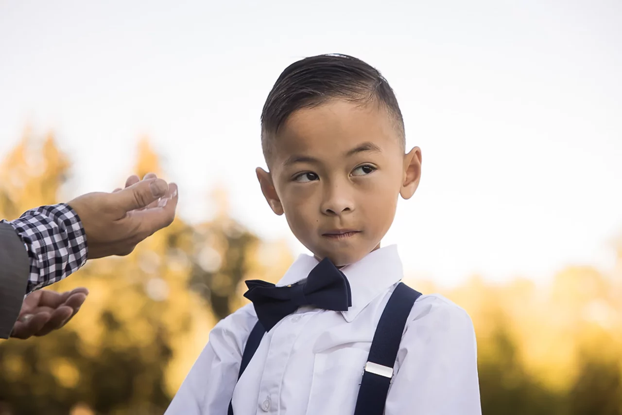 Documentary family photography - young boy in bow tie by paper bunny studios Edmonton