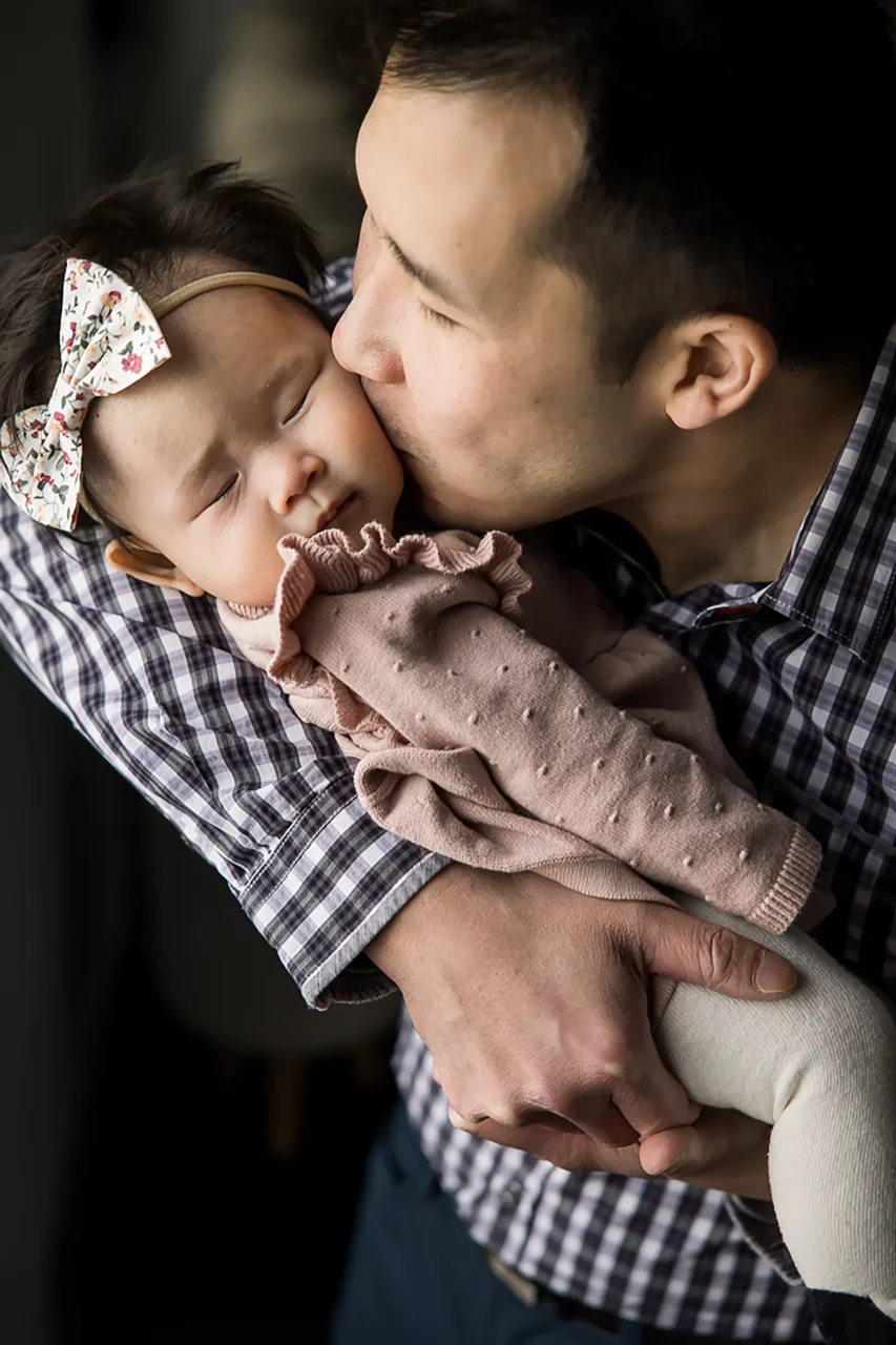 Newborn baby photos  - dad kissing daughter - by Paper Bunny Studios Edmonton