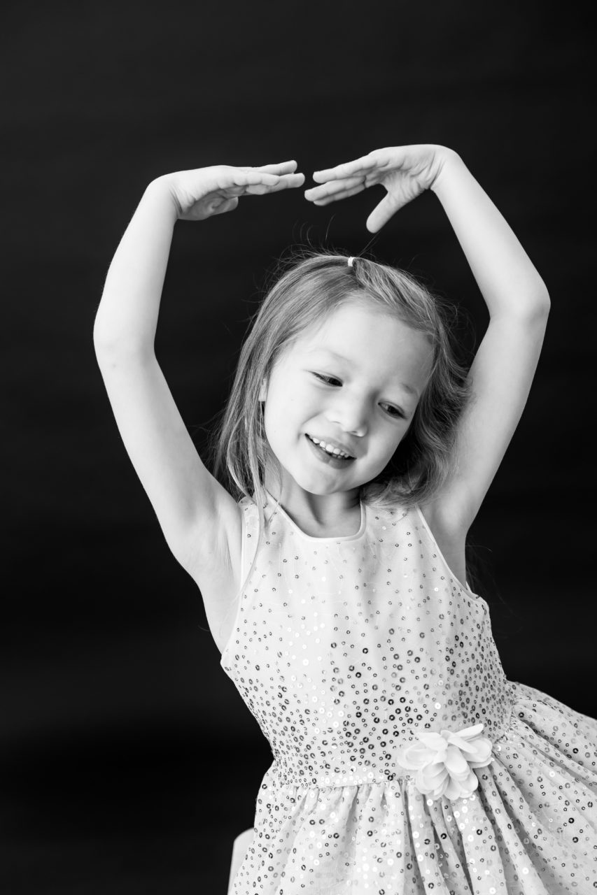 Black & white kids portrait of little girl dancing by Paper Bunny Studios Edmonton